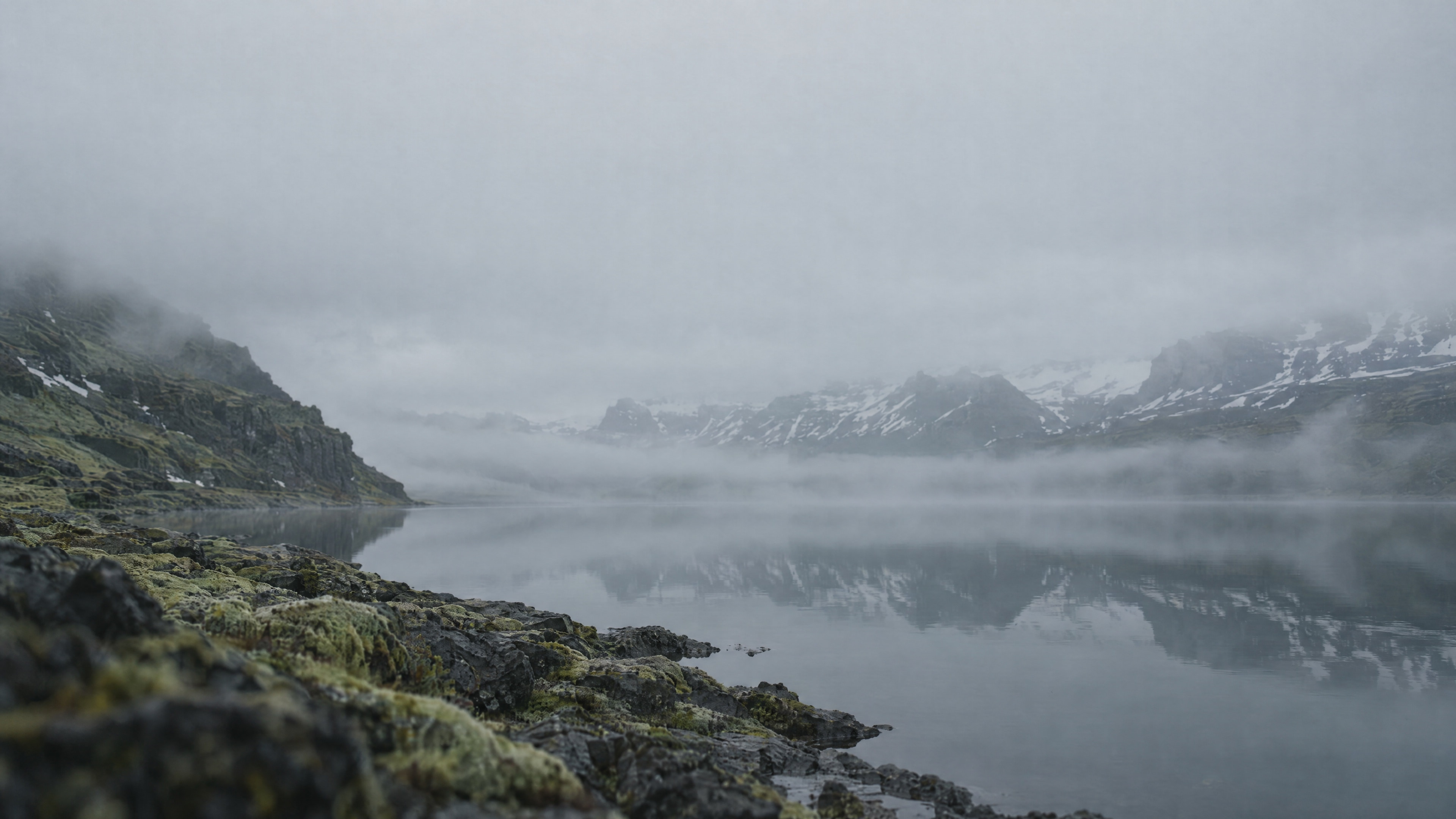 A glacial lake under dark Icelandic mountains